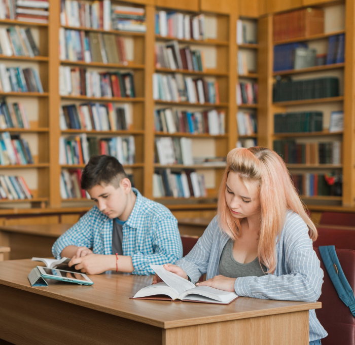 Two students reading in a school library