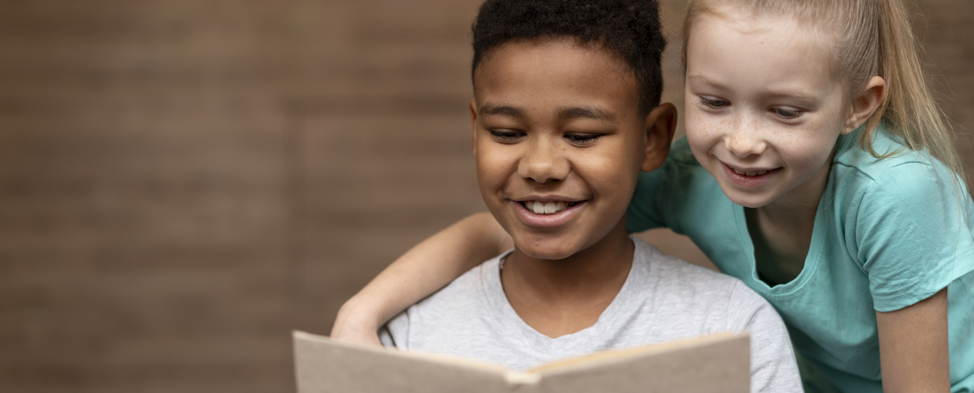 A smiling student reading in a school library